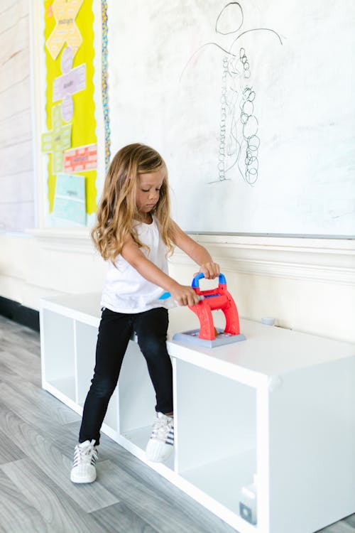 Girl Playing Toy in Classroom