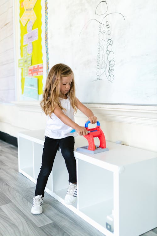 Girl Playing Toy in Classroom