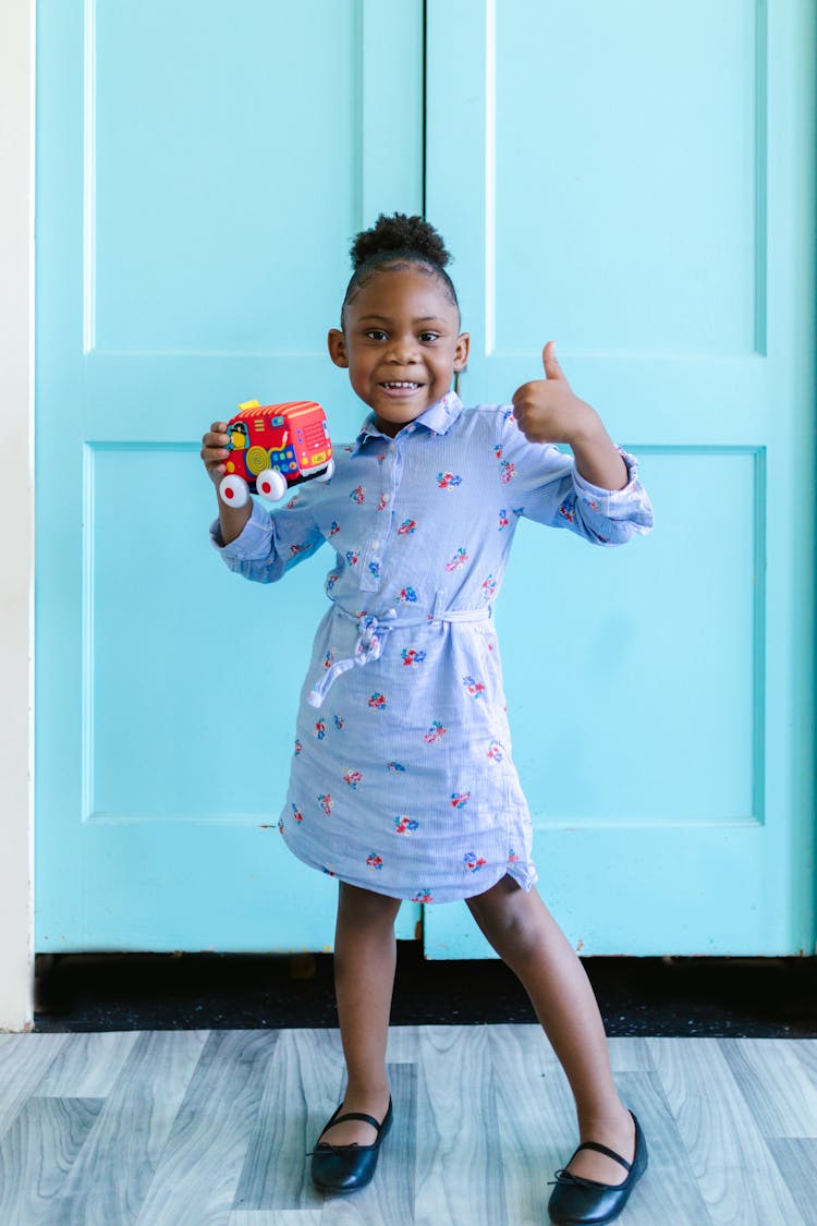 Girl Holding Toy Car