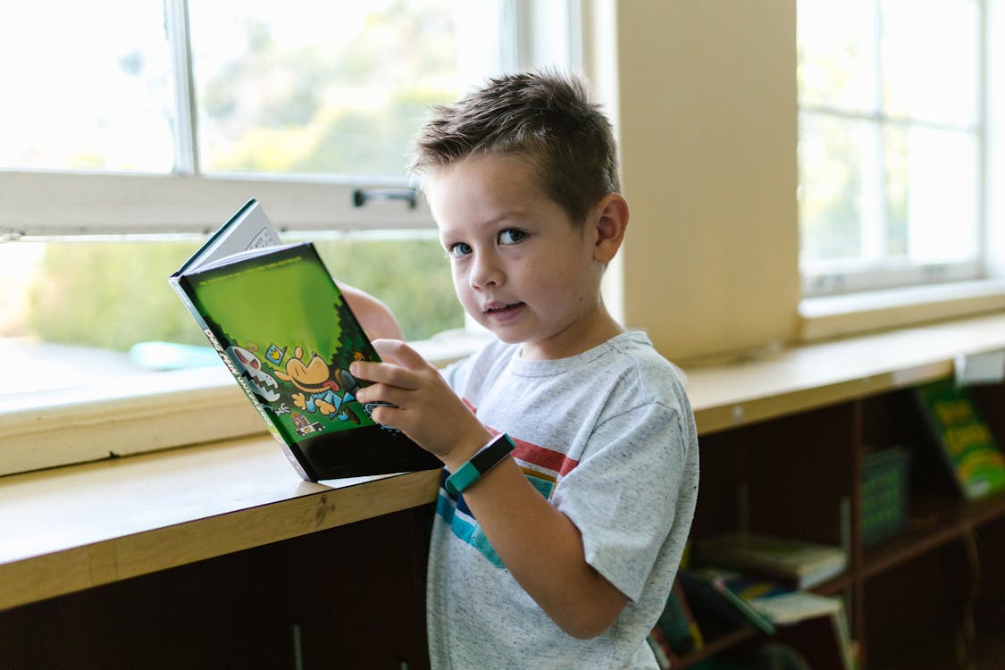 Free Boy in Purple Crew Neck T-shirt Holding Green Tablet Computer Stock Photo