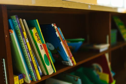 A vibrant collection of children's books neatly arranged on a wooden shelf.