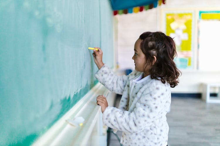 A Girl Writing On A Blackboard 