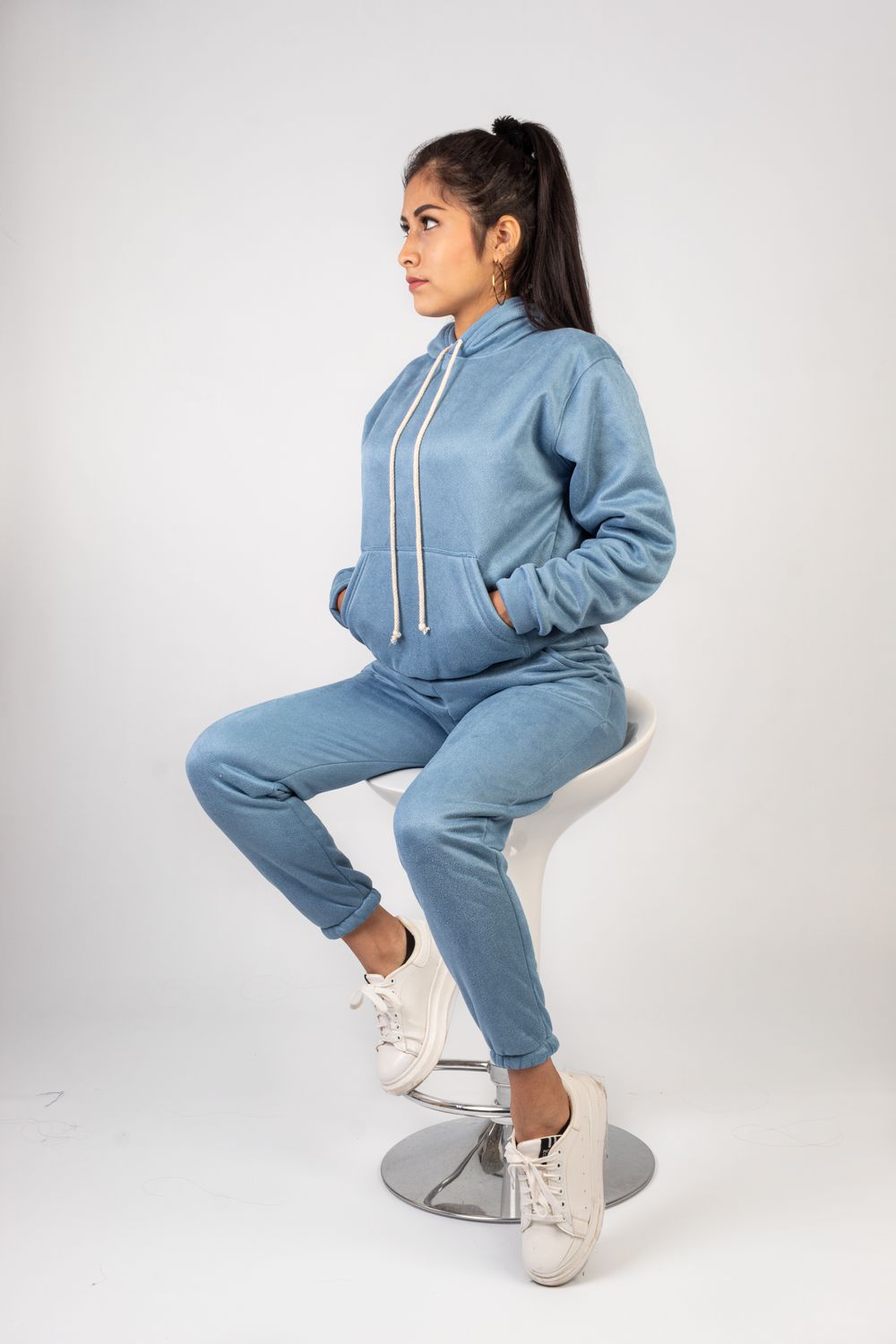 Woman wearing a coordinated tracksuit and jogger set in a studio