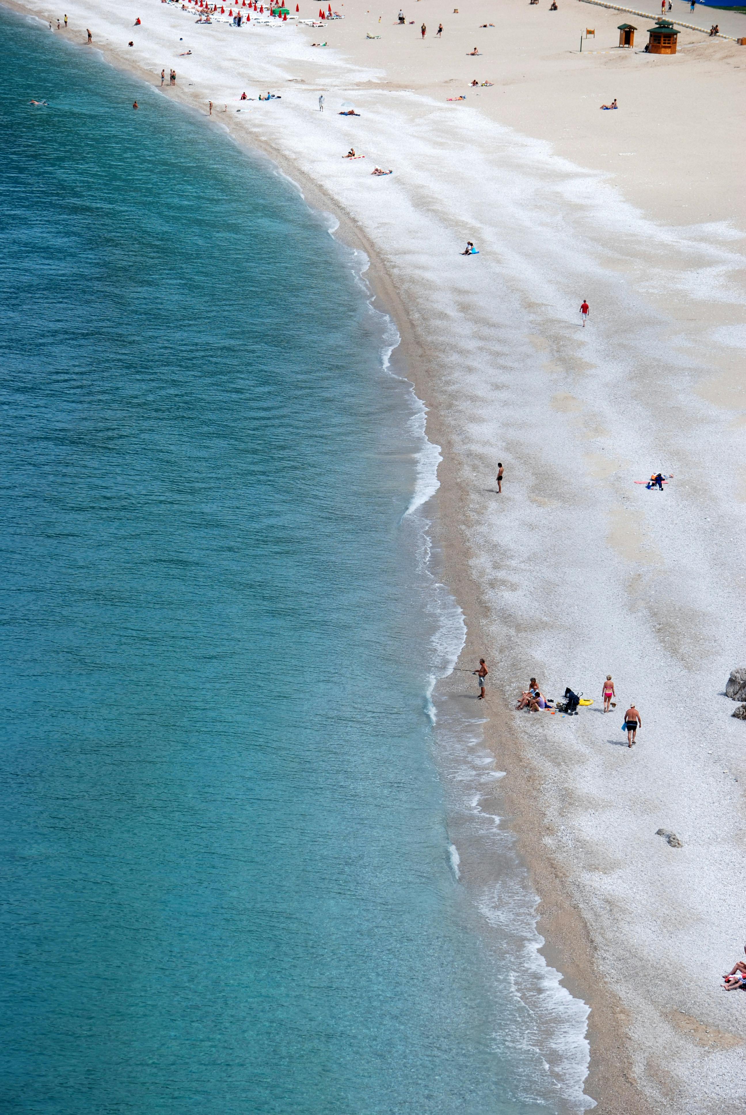 A scenic aerial view of a sandy beach in Fethiye, Türkiye, showcasing a vibrant coastline.