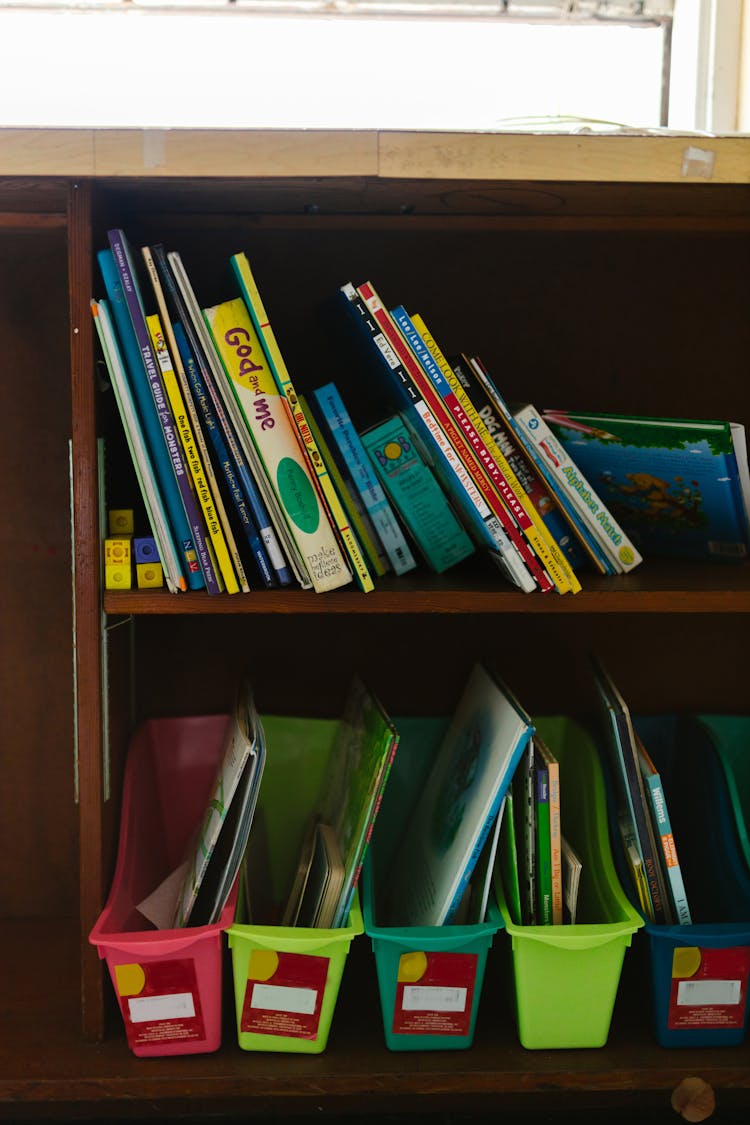 Books On Brown Wooden Shelves