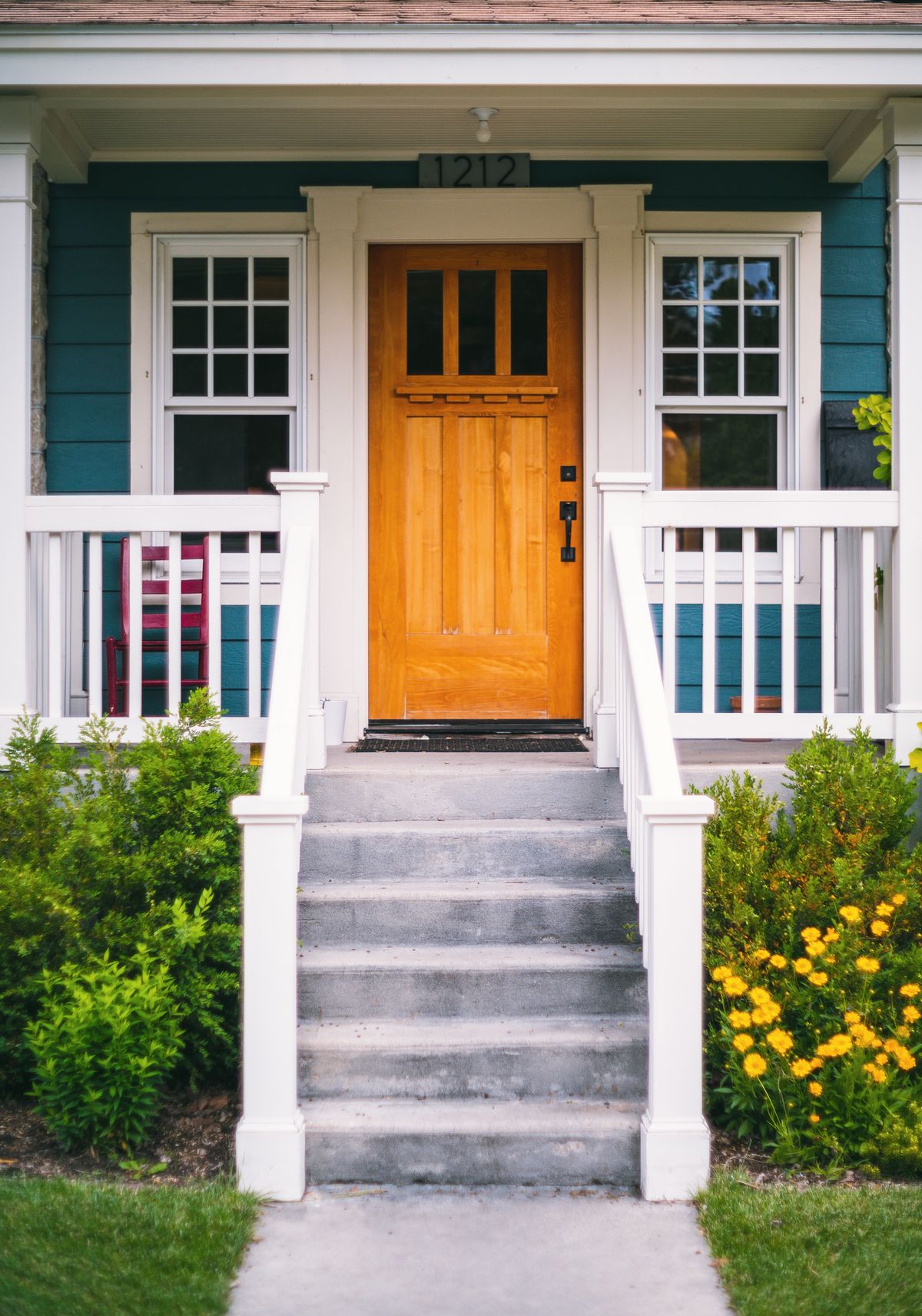 A welcoming neighborhood home with a porch and garden