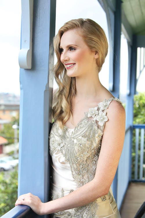 Woman in White Floral Lace Sleeveless Gown