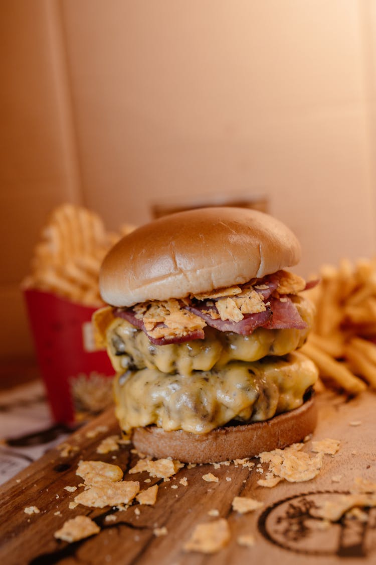 A Cheesy Burger On A Wooden Tray