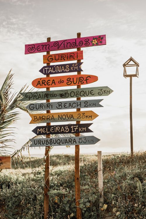 Free A vibrant assortment of directional signs in Brazil's scenic coastal landscape. Stock Photo
