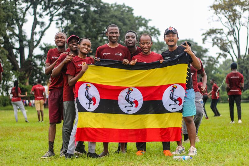Vibrant party table decorated with black, yellow, and red color scheme for Uganda Independence Day celebration