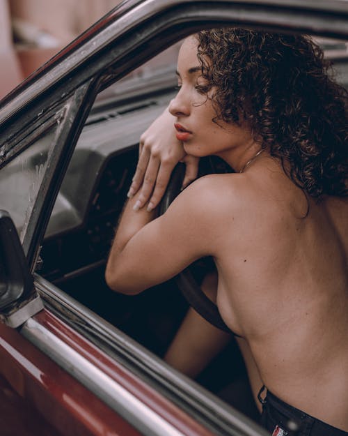 Free Topless Woman Sitting in the Car Stock Photo