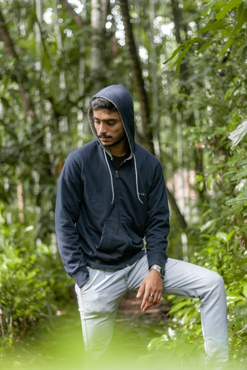 Man in Hoodie Jacket and Gray Pants Neat Green Plants