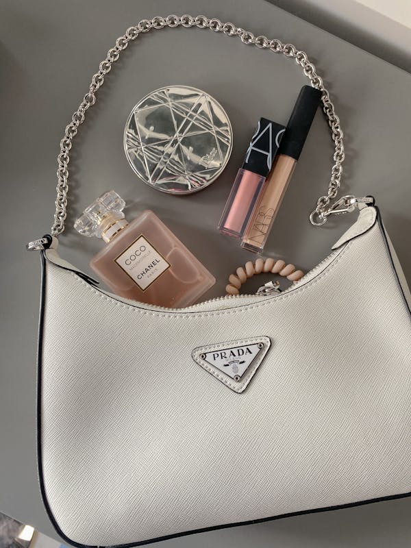 Flatlay Shot of a Bag with Makeup and Perfume