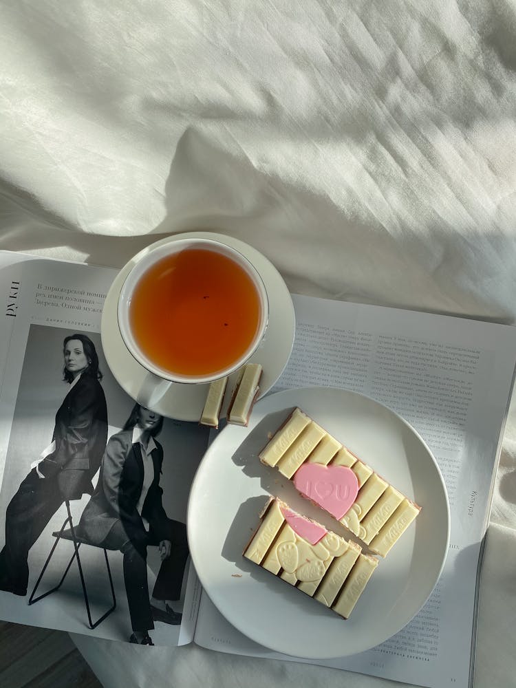 Plate With Sweet And A Cup Of Tea On A Fashion Magazine