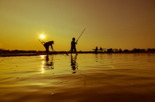 Silhouette of People on the Lake