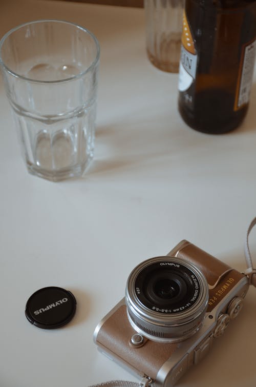 A Camera and a Glass on a Table