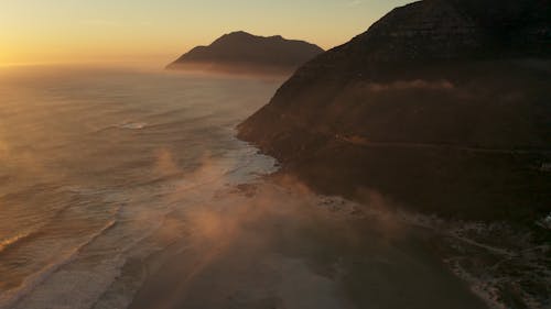 Aerial Photography of Mountains near Ocean during Sunrise