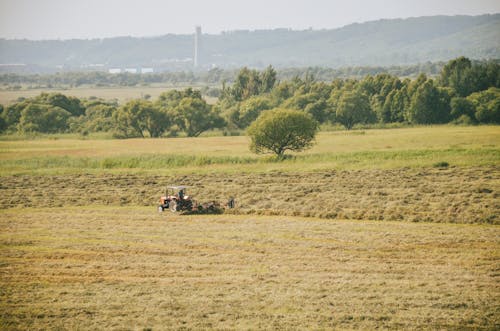 Free A Tractor Harvesting on the Field Stock Photo