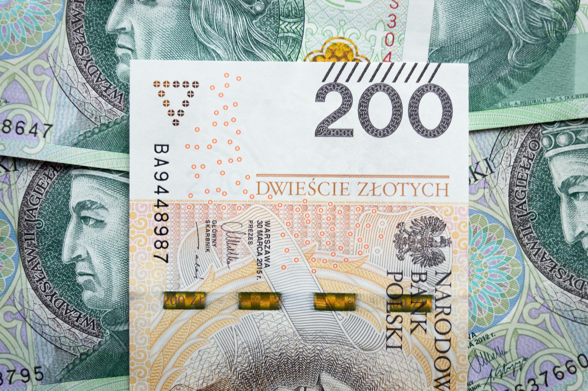 Detailed view of Polish 200 Zloty banknotes for financial and economic subjects.