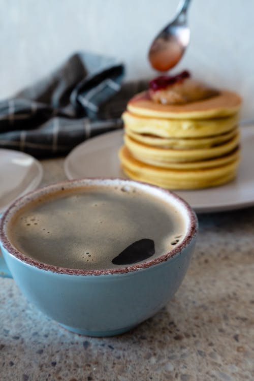 Free Cup of Coffee Near Ceramic Plate with Pancakes Stock Photo