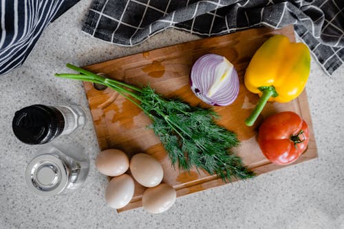 A Fresh Vegetables on a Wooden Chopping Board