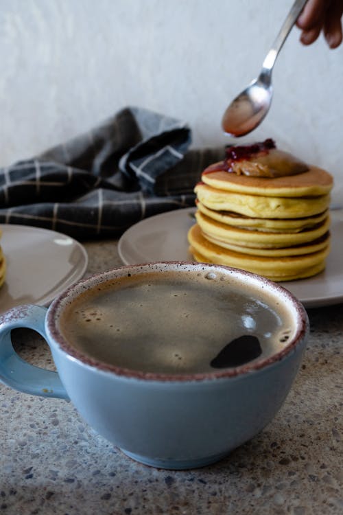 Free Cup of Coffee Near Pancakes Stock Photo