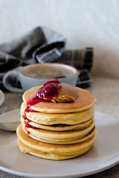 Free Pancakes with Red Syrup on White Ceramic Plate Stock Photo