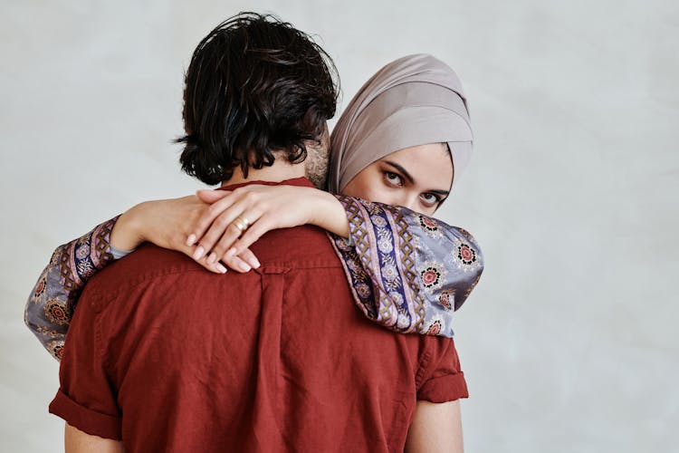 Woman In Hijab Hugging A Man Wearing Red Shirt