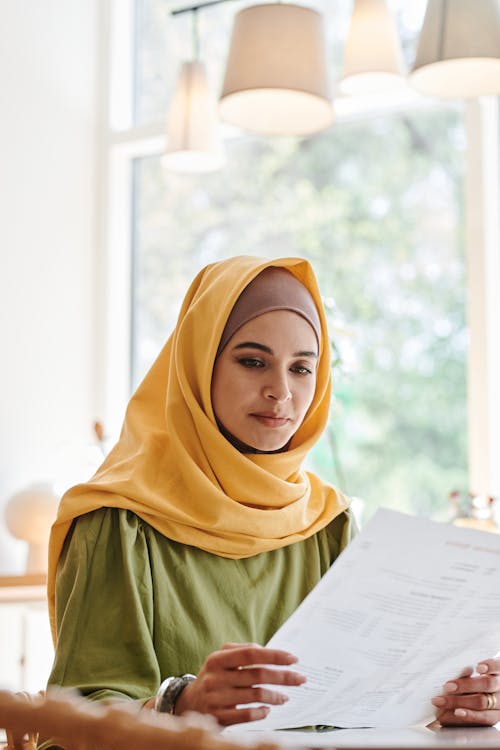 Woman in Yellow and Brown Hijab and Green Dress