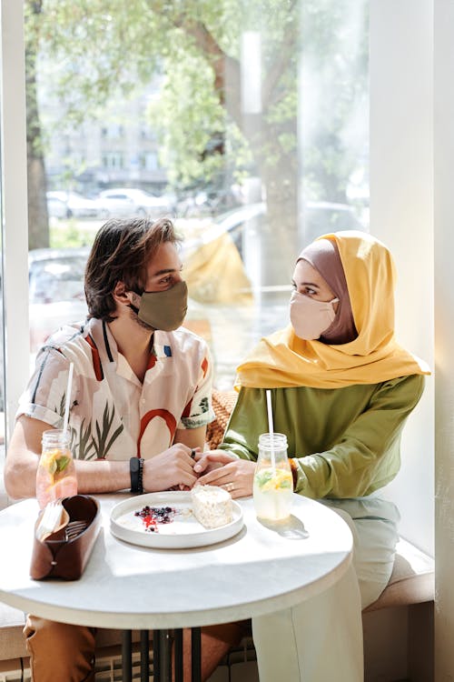Couple Wearing Face Masks Having a Date