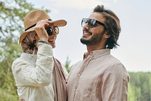 Couple Wearing Sunglasses Laughing