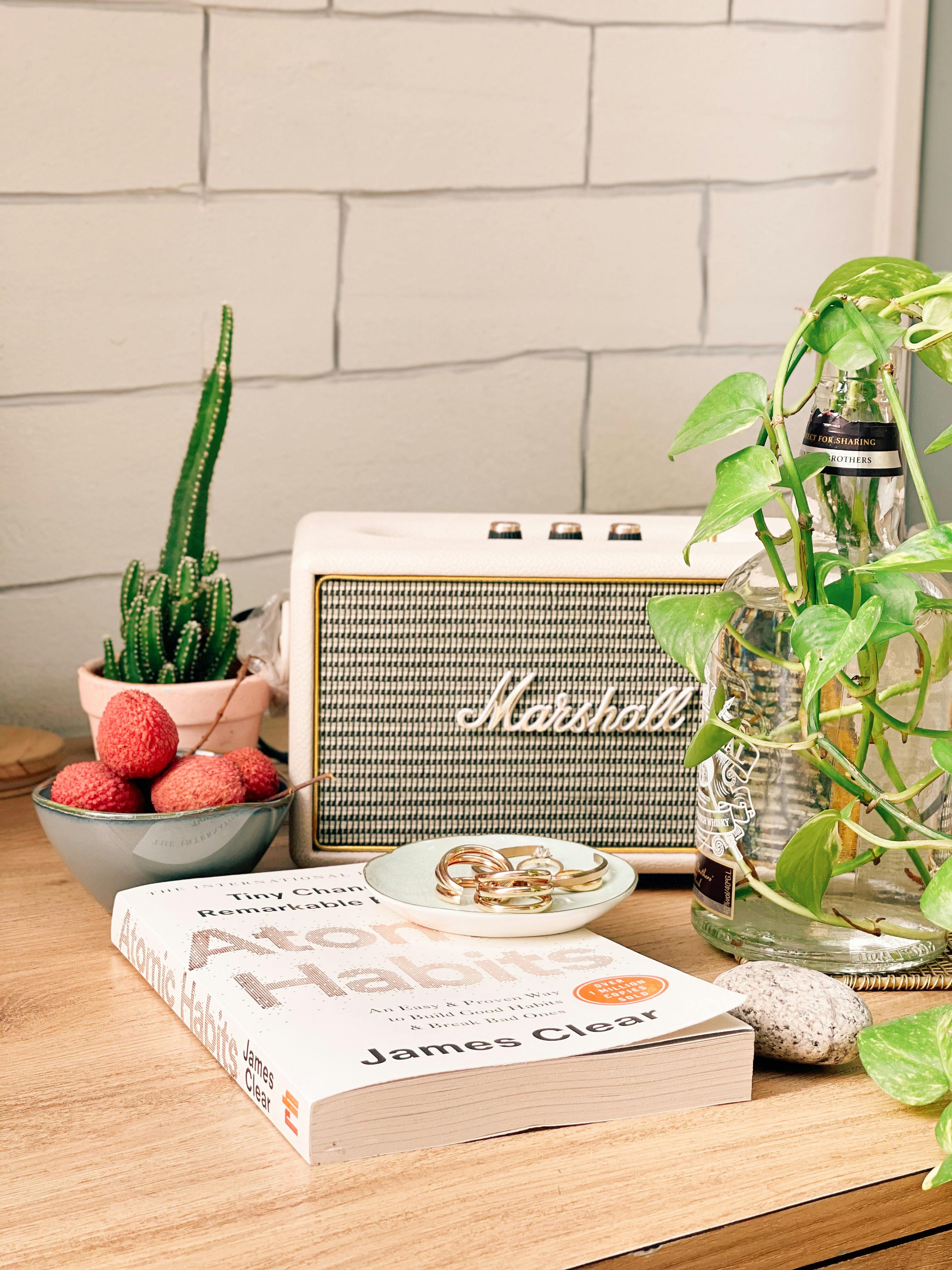 Free A book, fruits, and a vintage speaker on a cozy table setting indoors. Stock Photo
