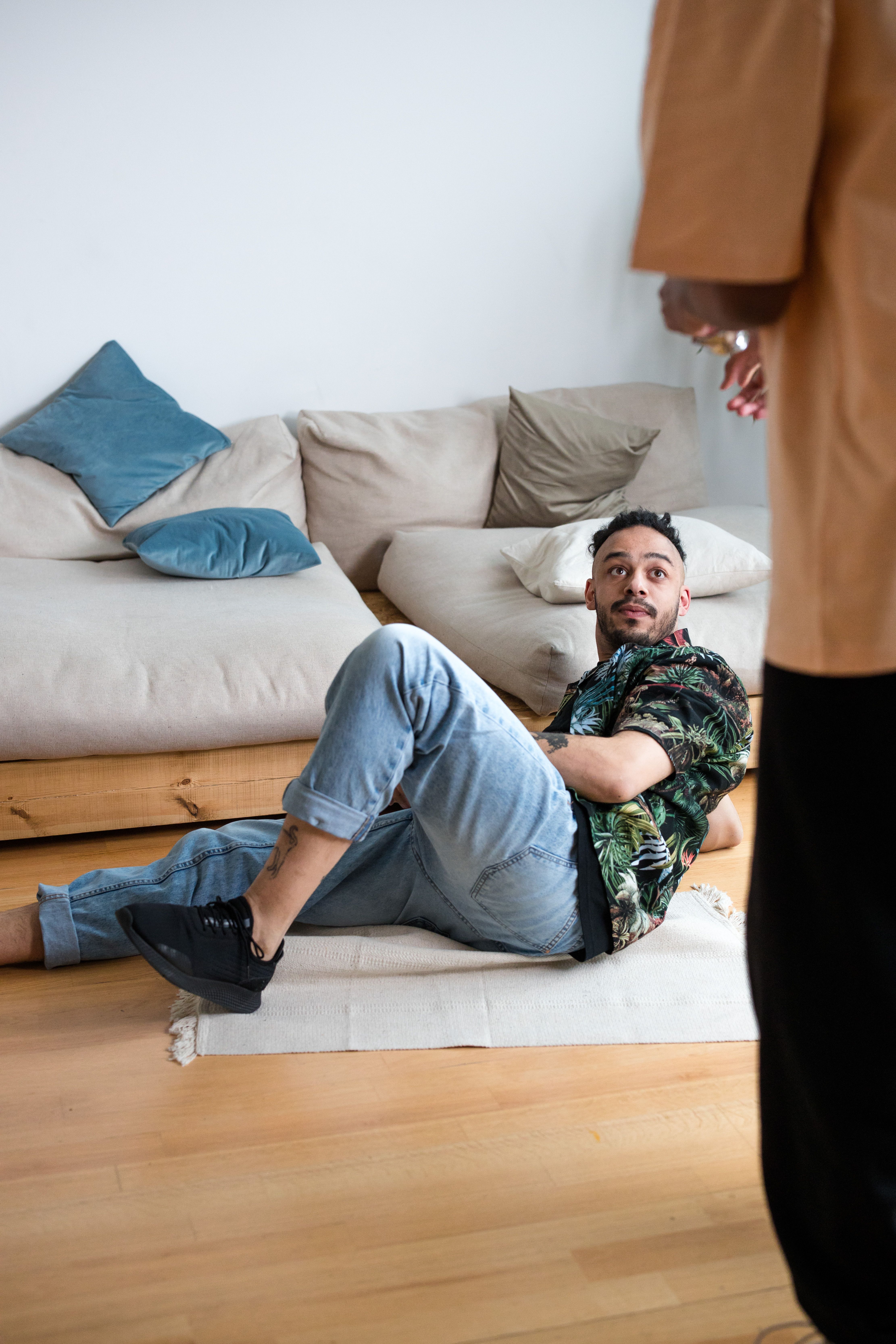 Man In Blue Denim Jeans Lying On White Couch Free Stock Photo