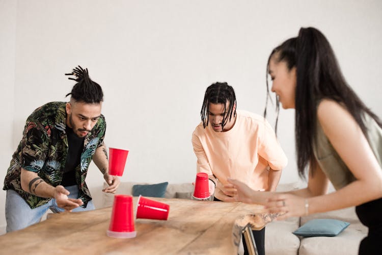 Friends Playing With Red Plastic Cups