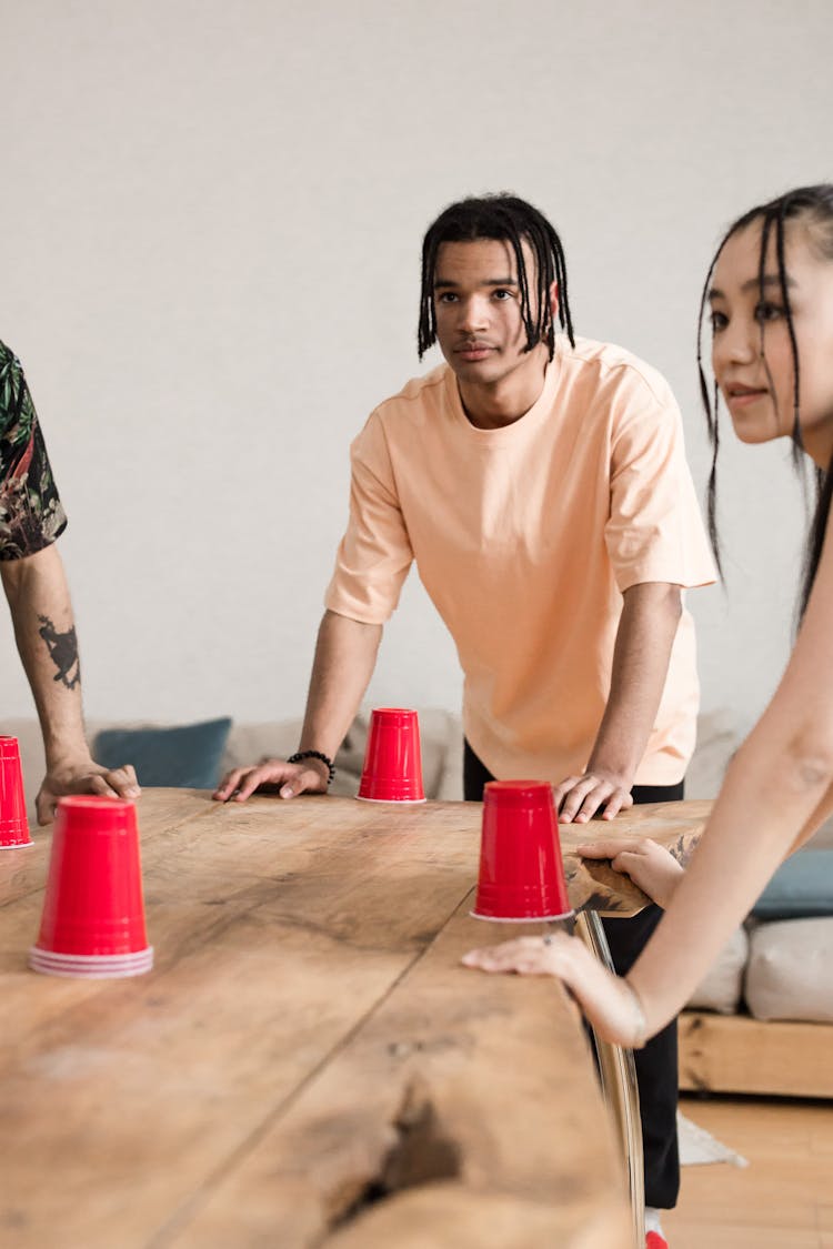 Friends Playing With Red Plastic Cups