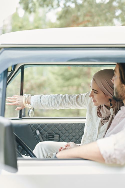 Free A happy couple sharing a moment during a drive, with a focus on their connection and journey. Stock Photo