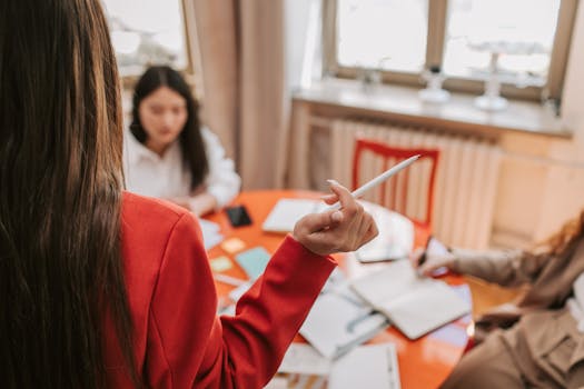 Business professionals engaged in a collaborative meeting in a modern office space.