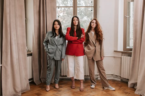 Women in Blazers Standing on Brown Wooden Floor