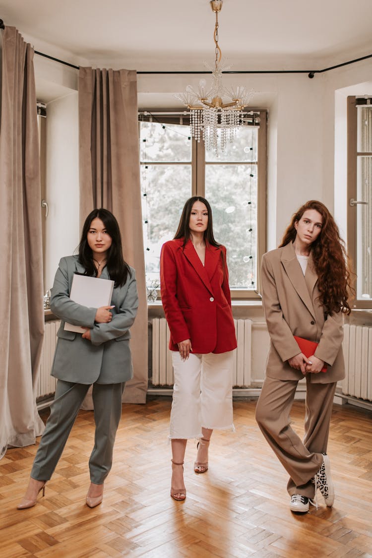 Three Women In Business Attires Inside An Office