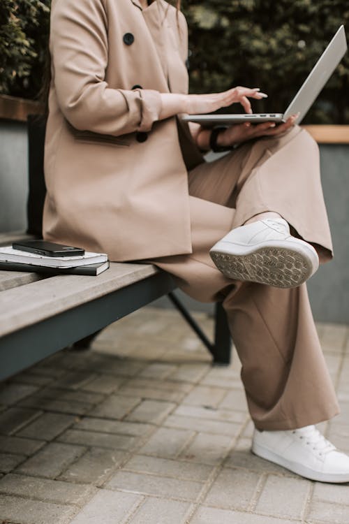 Person in Beige Suit with Laptop