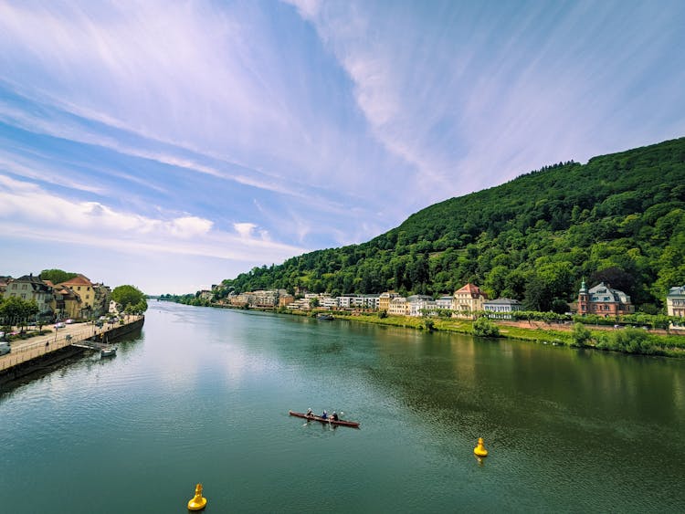 People Sailing In Canoe In Lake 