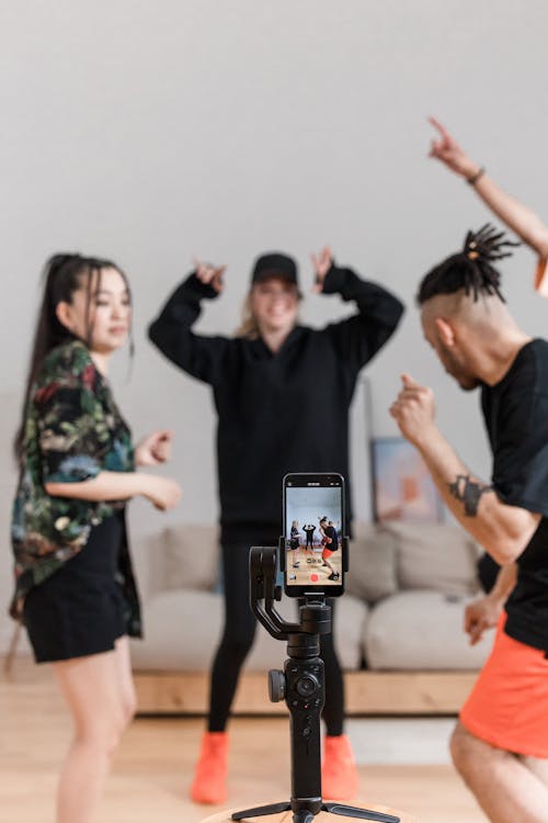 Shallow focus of smiling people recording a TikTok Promotion.