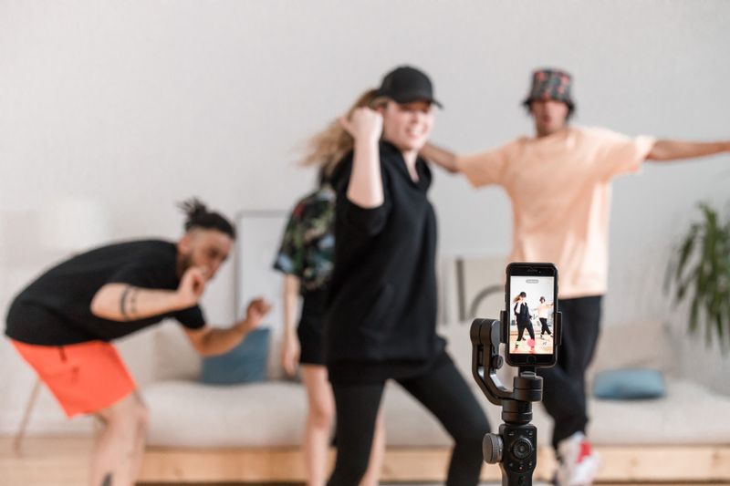 A diverse group having fun dancing for social media video content indoors.