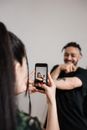 Man in Black Crew Neck T-shirt Holding Black Smartphone