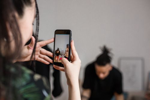Free Close-up of a person recording a video with a smartphone indoors, focusing on creative content creation. Stock Photo