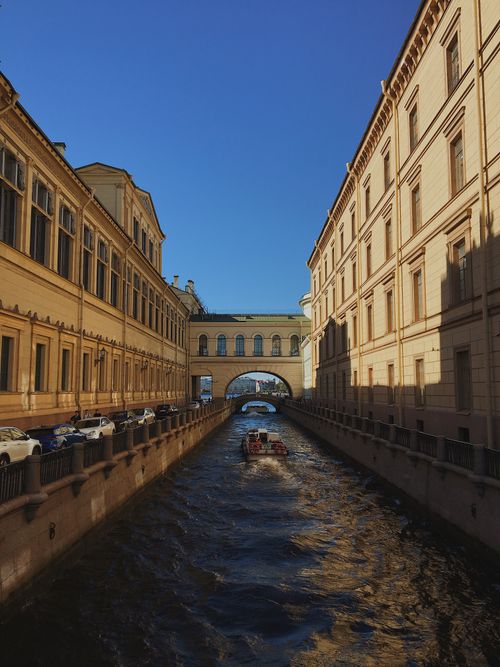 Free A speedboat cruises through Winter Canal, flanked by historic buildings in Saint Petersburg. Stock Photo