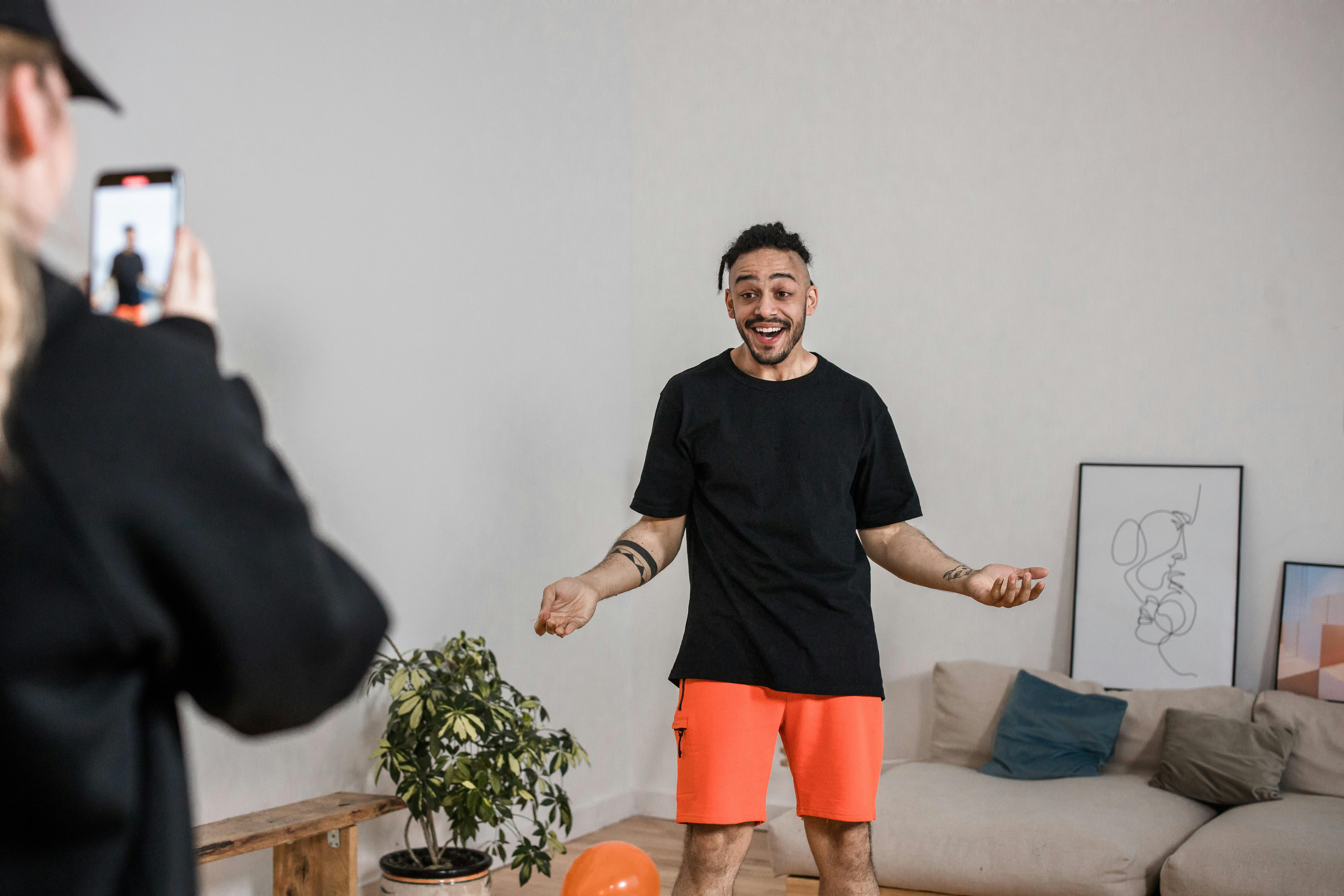 man in black round neck shirt recording a video