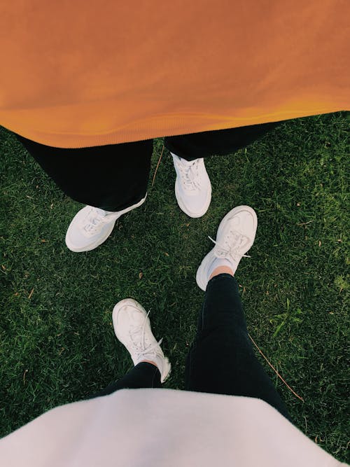 Two People Wearing White Sneakers