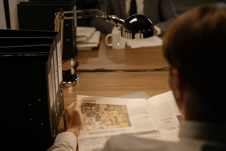 A Person Reading A Newspaper