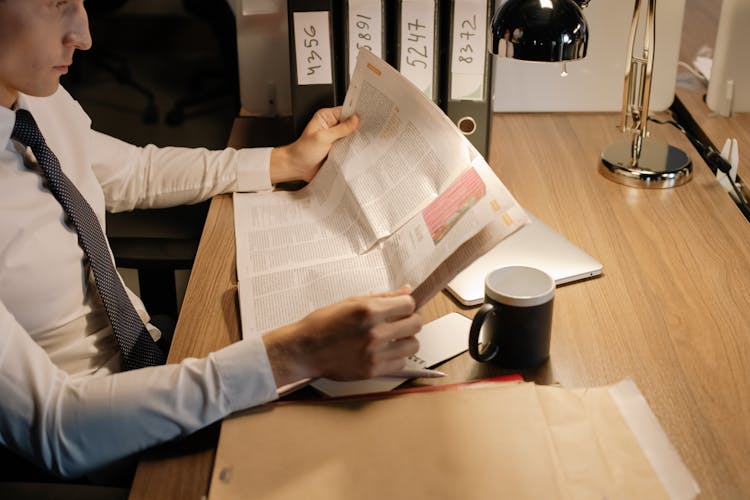 A Man Reading A Newspaper 